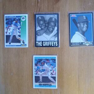 Four Ken Griffey Jr. baseball cards including The Griffeys with his dad
